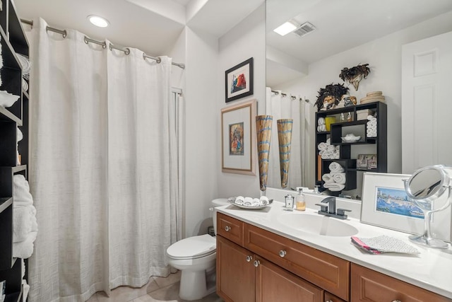 bathroom with tile patterned floors, vanity, and toilet