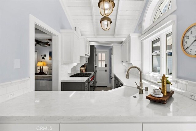 kitchen featuring wooden ceiling, sink, white cabinets, and lofted ceiling with beams