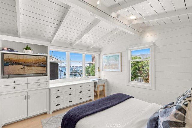 bedroom featuring vaulted ceiling with beams and wood walls