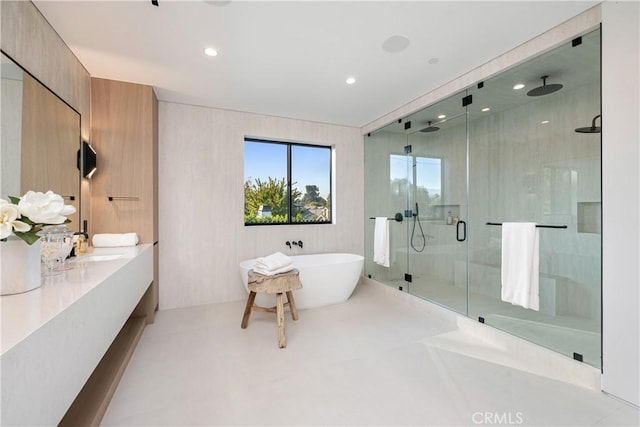 bathroom featuring vanity and separate shower and tub