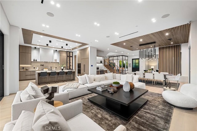 living room featuring a raised ceiling and wood ceiling