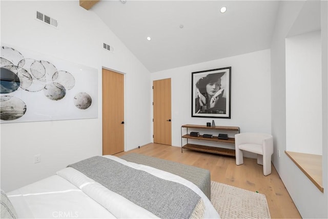 bedroom featuring high vaulted ceiling and hardwood / wood-style floors