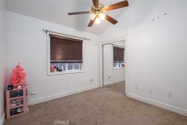 unfurnished bedroom featuring ceiling fan, carpet flooring, and lofted ceiling