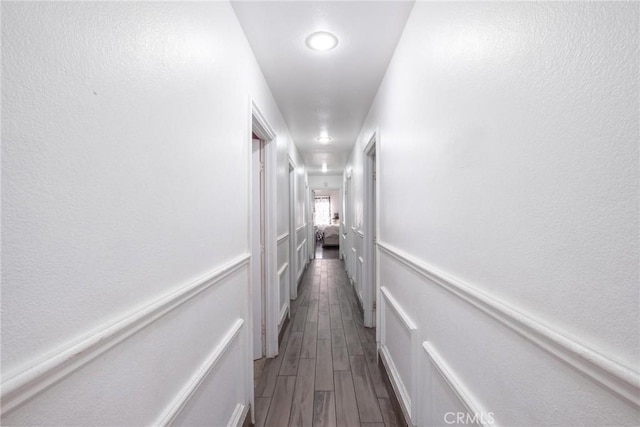 hallway featuring dark hardwood / wood-style flooring