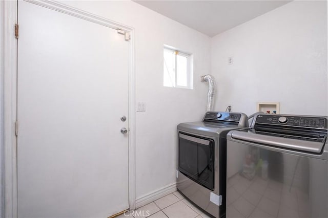 laundry room with separate washer and dryer and light tile patterned flooring