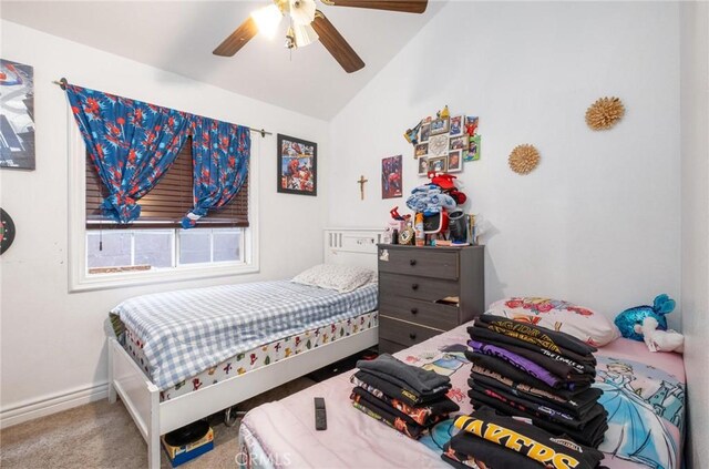 bedroom with ceiling fan, carpet floors, and vaulted ceiling