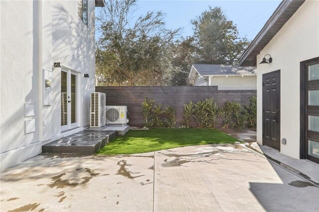 view of yard with ac unit, a patio, and french doors