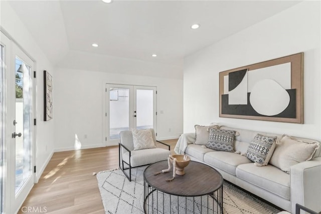 living room featuring french doors and light wood-type flooring