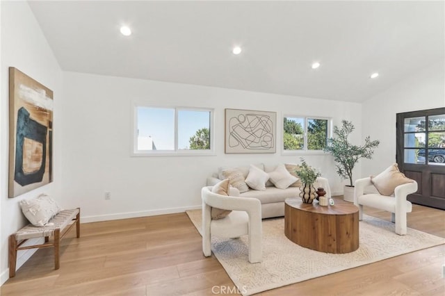 living room with light hardwood / wood-style flooring and lofted ceiling