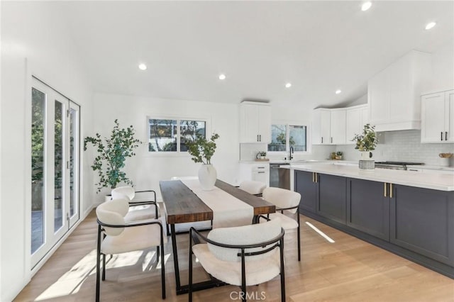 dining area with sink and light hardwood / wood-style flooring