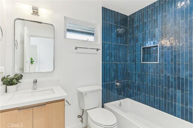 full bathroom with toilet, tiled shower / bath, and vanity