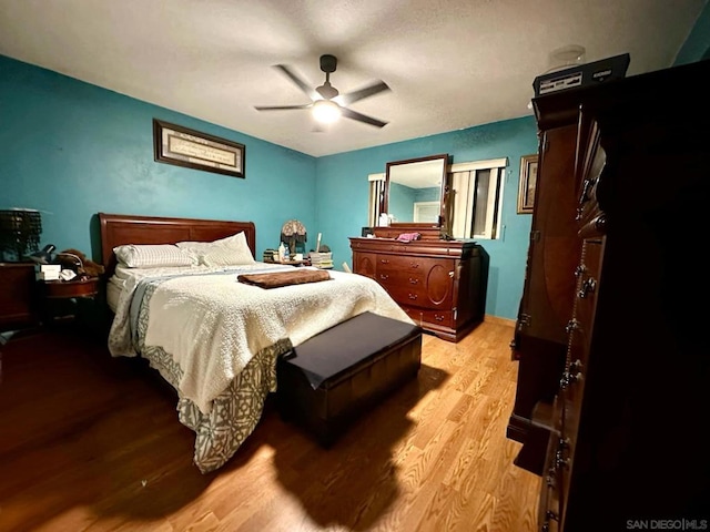 bedroom with ceiling fan and light hardwood / wood-style flooring