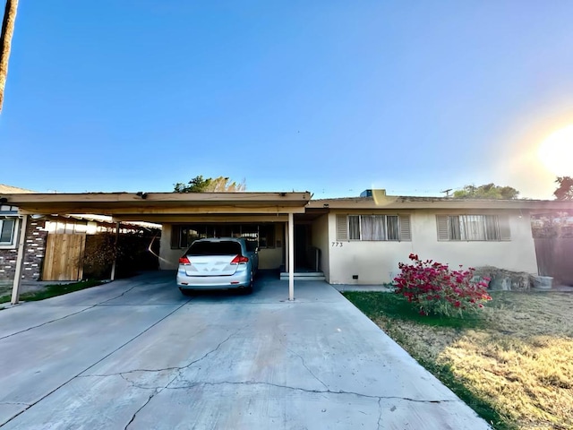 ranch-style house featuring a carport