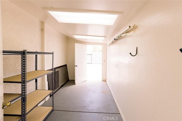 hallway with concrete floors