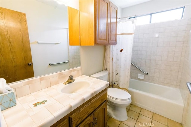 full bathroom featuring shower / bath combo with shower curtain, tile patterned floors, vanity, and toilet