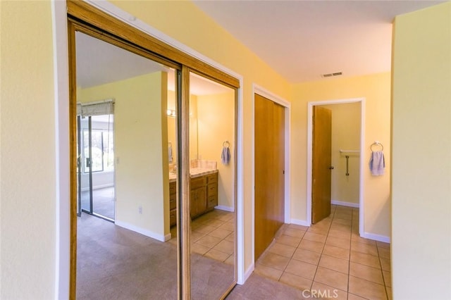 hallway featuring light tile patterned flooring