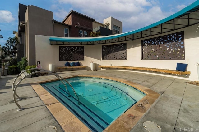 view of pool with an in ground hot tub