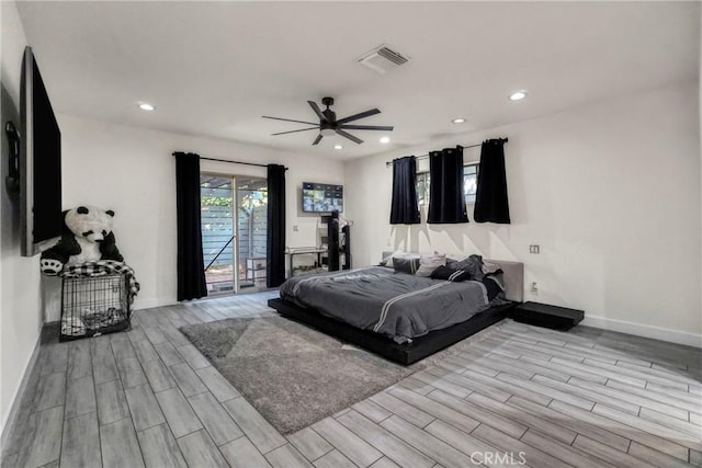 bedroom featuring access to outside, recessed lighting, visible vents, and wood tiled floor