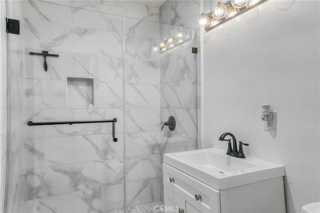 bathroom featuring vanity and a marble finish shower