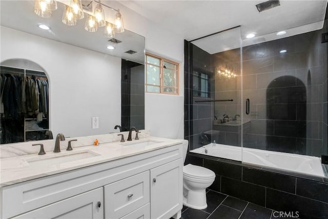 full bathroom featuring enclosed tub / shower combo, toilet, vanity, and tile patterned flooring