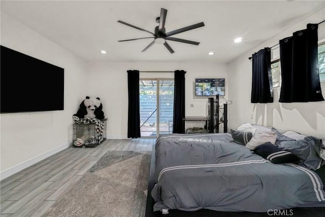 bedroom featuring ceiling fan, light hardwood / wood-style floors, and access to outside