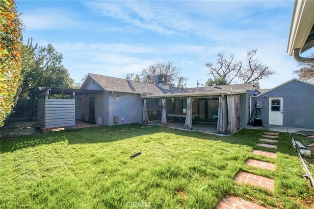 rear view of property featuring a yard, central air condition unit, a patio area, and a pergola