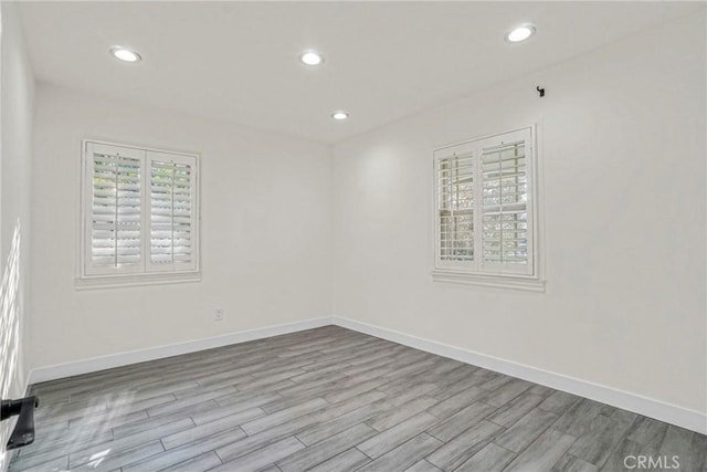 unfurnished room with light wood-type flooring