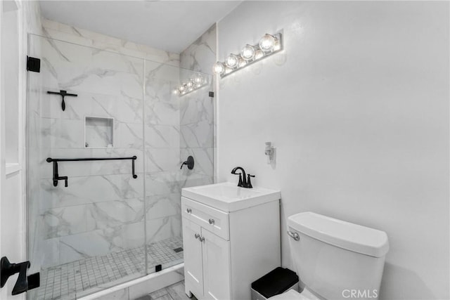 bathroom featuring an enclosed shower, vanity, and toilet