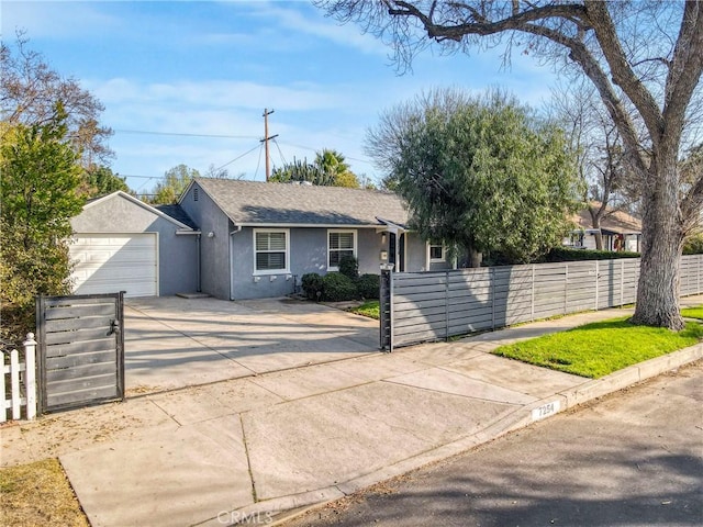 ranch-style house with stucco siding, a garage, a fenced front yard, and concrete driveway