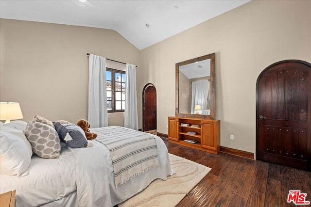 bedroom with lofted ceiling and dark hardwood / wood-style flooring