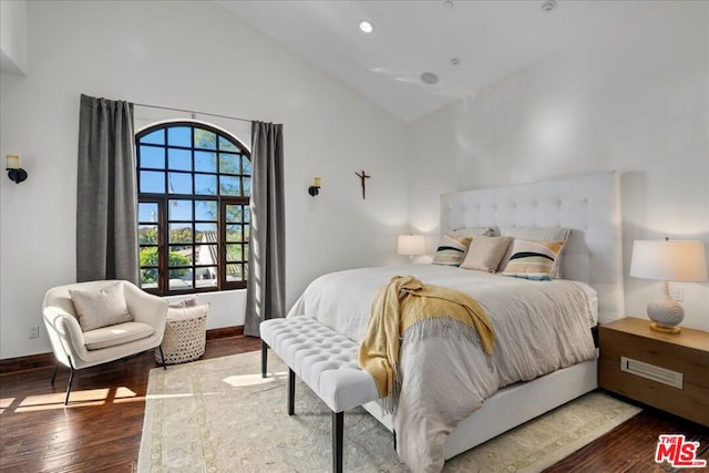 bedroom featuring dark hardwood / wood-style floors and high vaulted ceiling