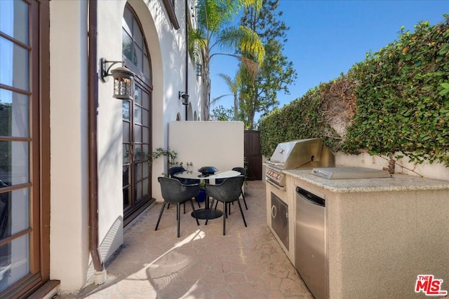 view of patio featuring a grill and an outdoor kitchen