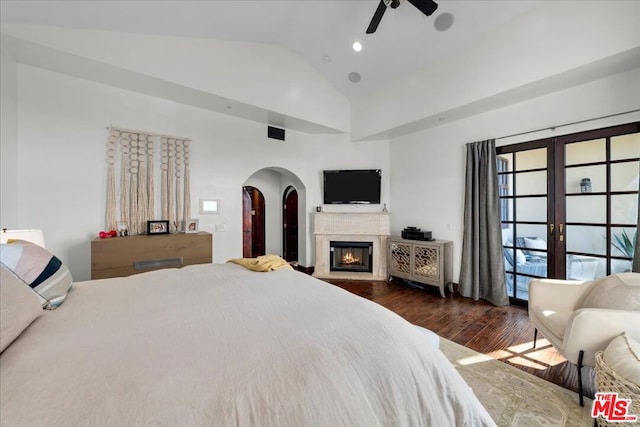 bedroom featuring ceiling fan, vaulted ceiling, dark wood-type flooring, and access to exterior