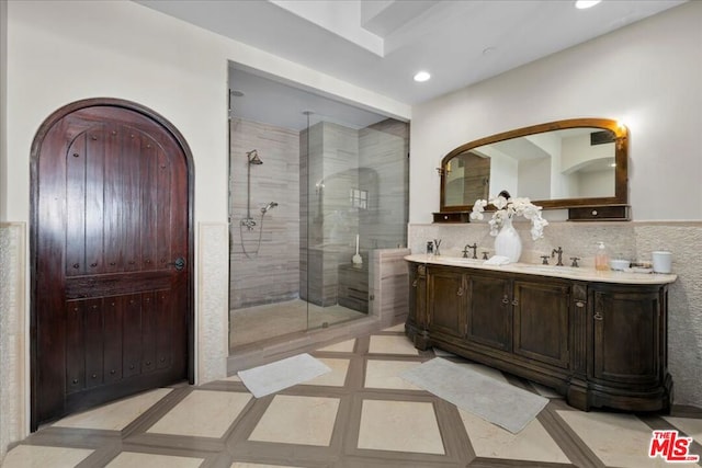 bathroom with vanity, a shower with door, and tile patterned floors