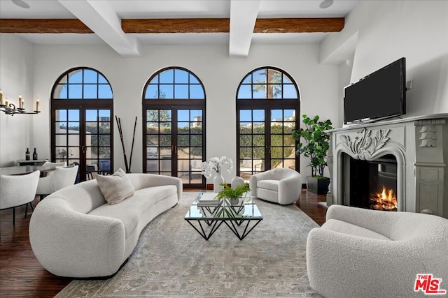 living room featuring wood-type flooring, beam ceiling, and french doors