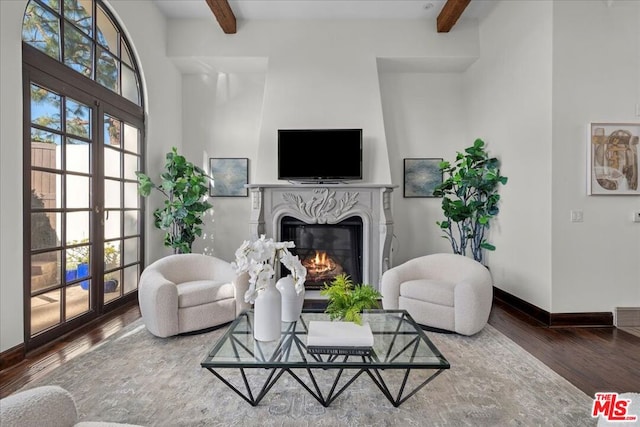 living room featuring wood-type flooring, beam ceiling, and french doors