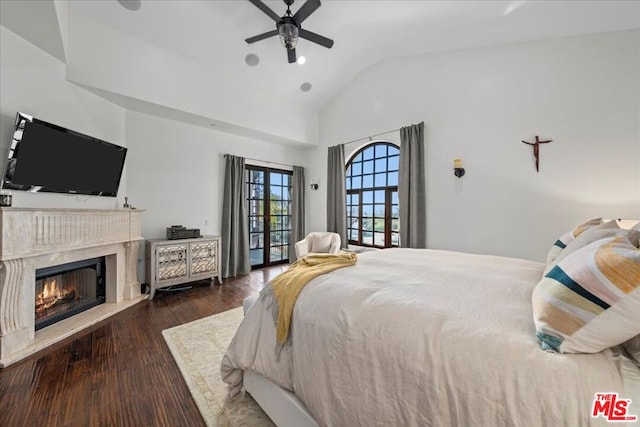 bedroom featuring lofted ceiling, dark wood-type flooring, a premium fireplace, access to outside, and ceiling fan