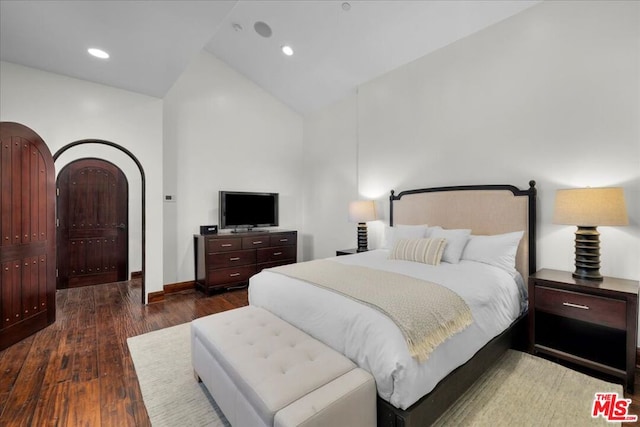 bedroom featuring vaulted ceiling and dark hardwood / wood-style floors