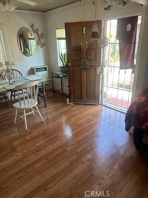 dining room with ornamental molding and hardwood / wood-style flooring