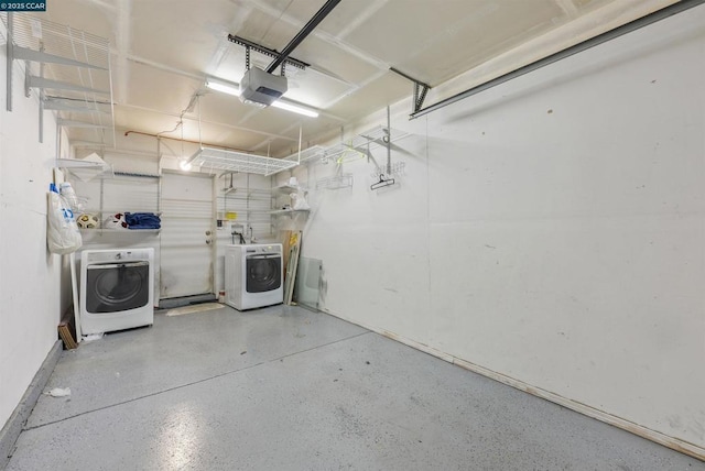 garage featuring washing machine and clothes dryer and a garage door opener