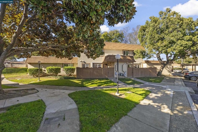 mediterranean / spanish-style house with a front lawn