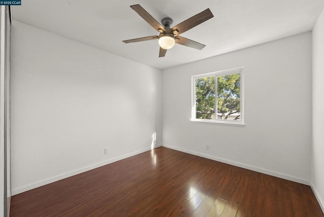 empty room featuring ceiling fan and dark hardwood / wood-style flooring