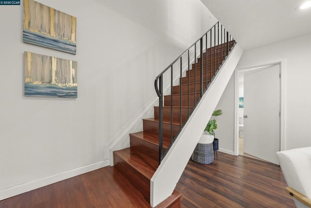 stairs with hardwood / wood-style flooring