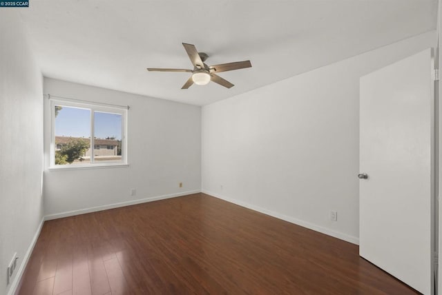 empty room with dark hardwood / wood-style floors and ceiling fan