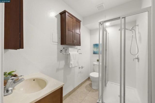 bathroom with toilet, a shower with shower door, tile patterned floors, and vanity