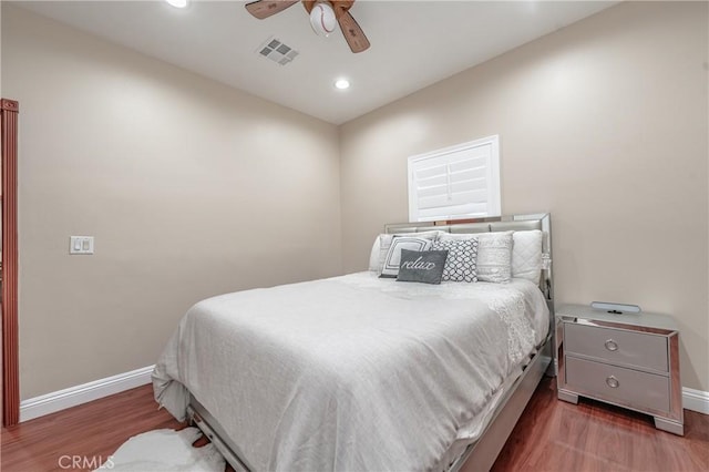 bedroom with dark wood-type flooring and ceiling fan