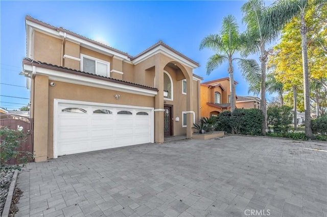 mediterranean / spanish-style home featuring a garage