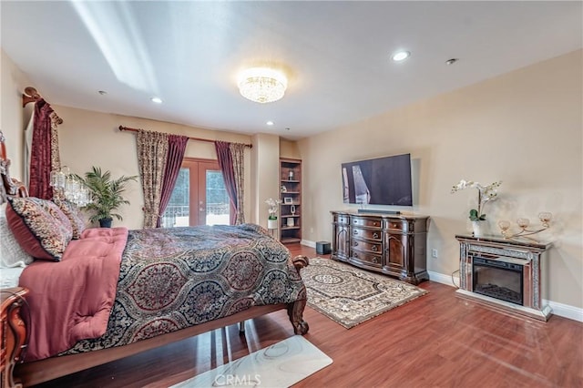 bedroom with hardwood / wood-style flooring and french doors