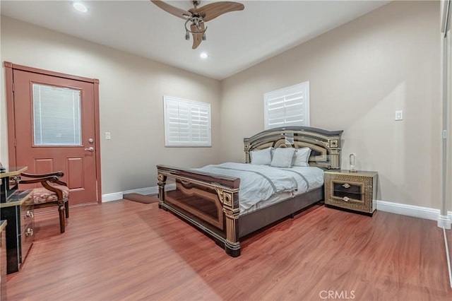 bedroom with wood-type flooring and ceiling fan