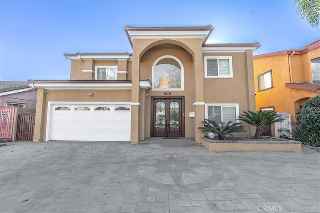 mediterranean / spanish-style home with french doors